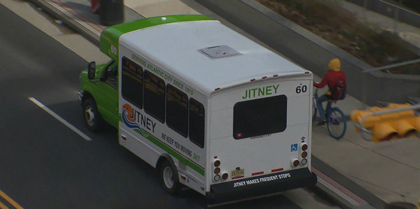 An aerial view of a shuttle bus driving on the street.