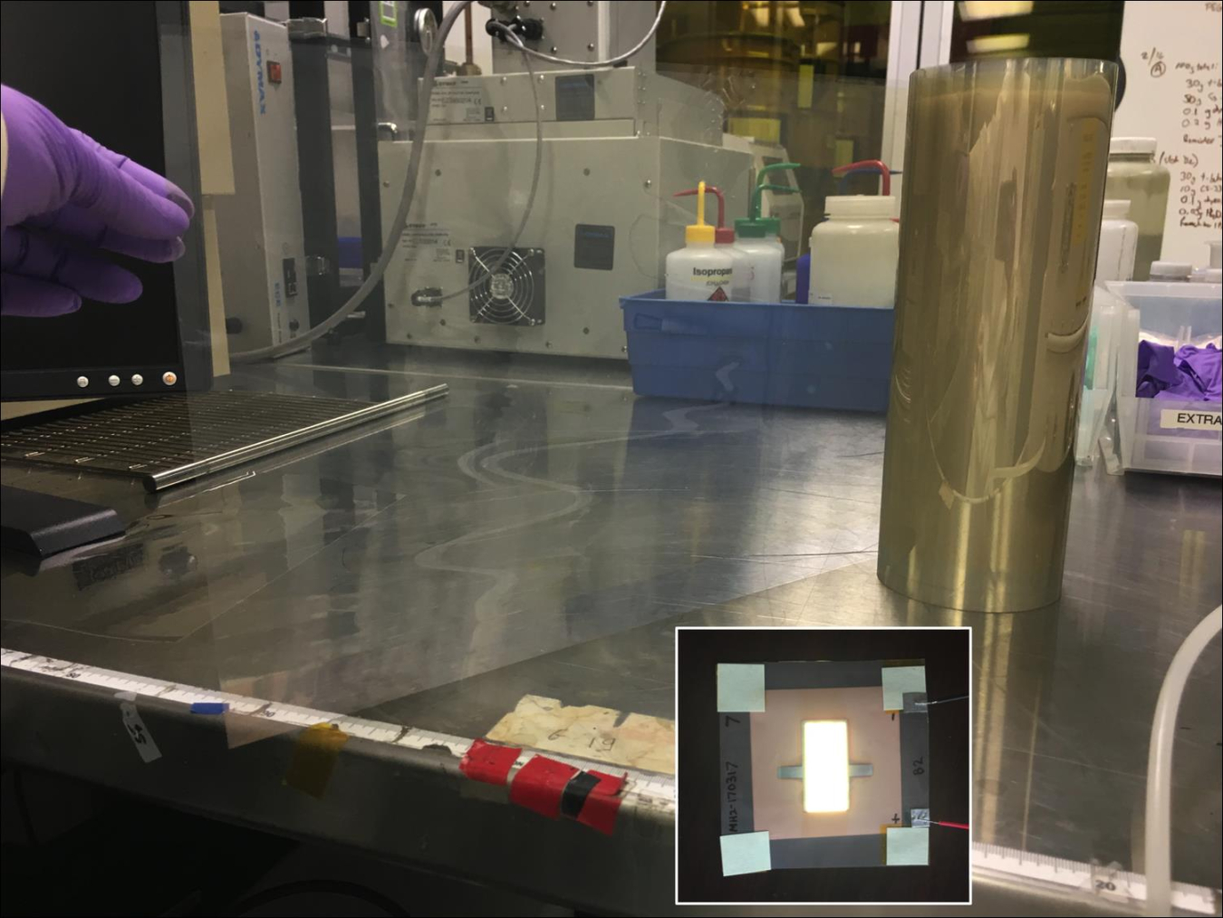 Photo showing manufacturing of OLED substrates, with an inset showing an OLED fabricated with the substrate.