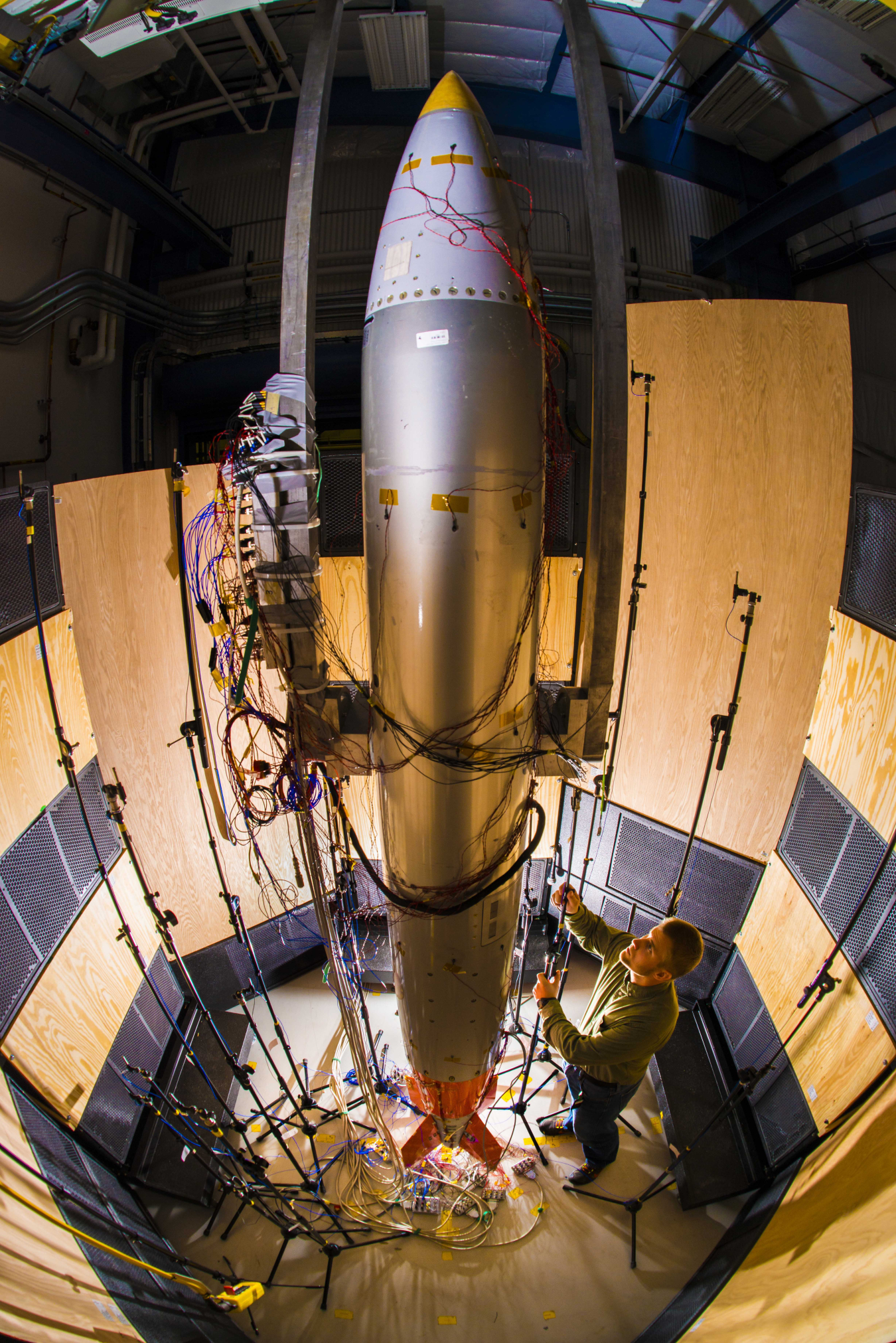 Sandia National Laboratory mechanical engineer Ryan Schultz adjusts a microphone for an acoustic test on a B61