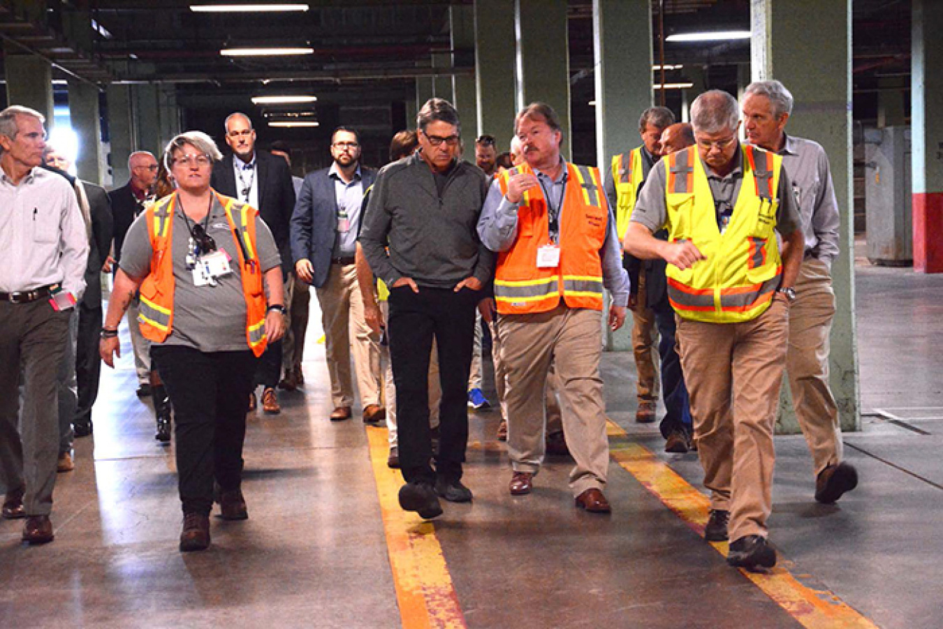 Sen. Rob Portman, contractor Fluor-BWXT Portsmouth’s Connie Martin, Secretary Rick Perry, EM PPPO Manager Robert Edwards, Fluor-BWXT’s Bob Leonard, and Acting EM Assistant Secretary Jim Owendoff walk through the half-mile-long X-333 Process Building.