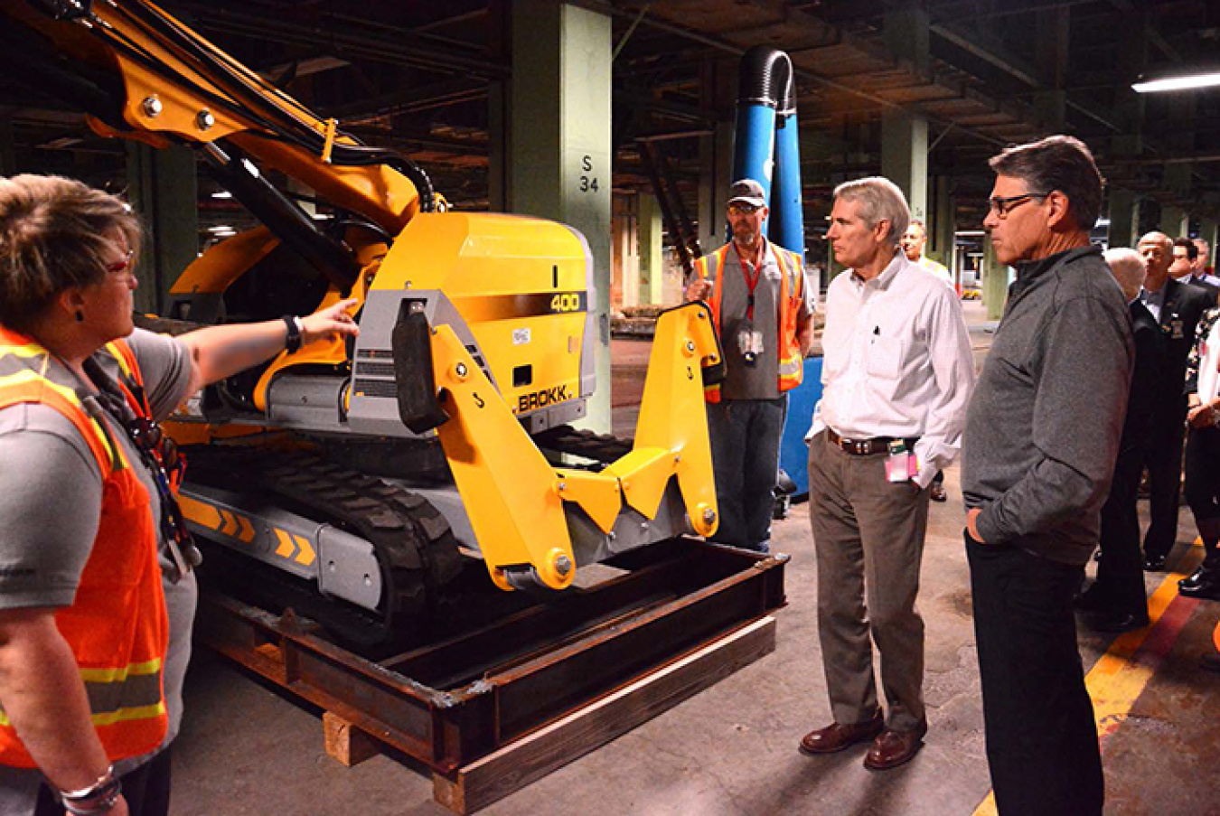 Connie Martin (left) and Chris Ashley (center) of Fluor-BWXT Portsmouth, the cleanup contractor for EM’s Portsmouth Site in southern Ohio, explain to U.S. Sen. Portman and Secretary Rick Perry the capabilities of a remote-controlled robotic arm.