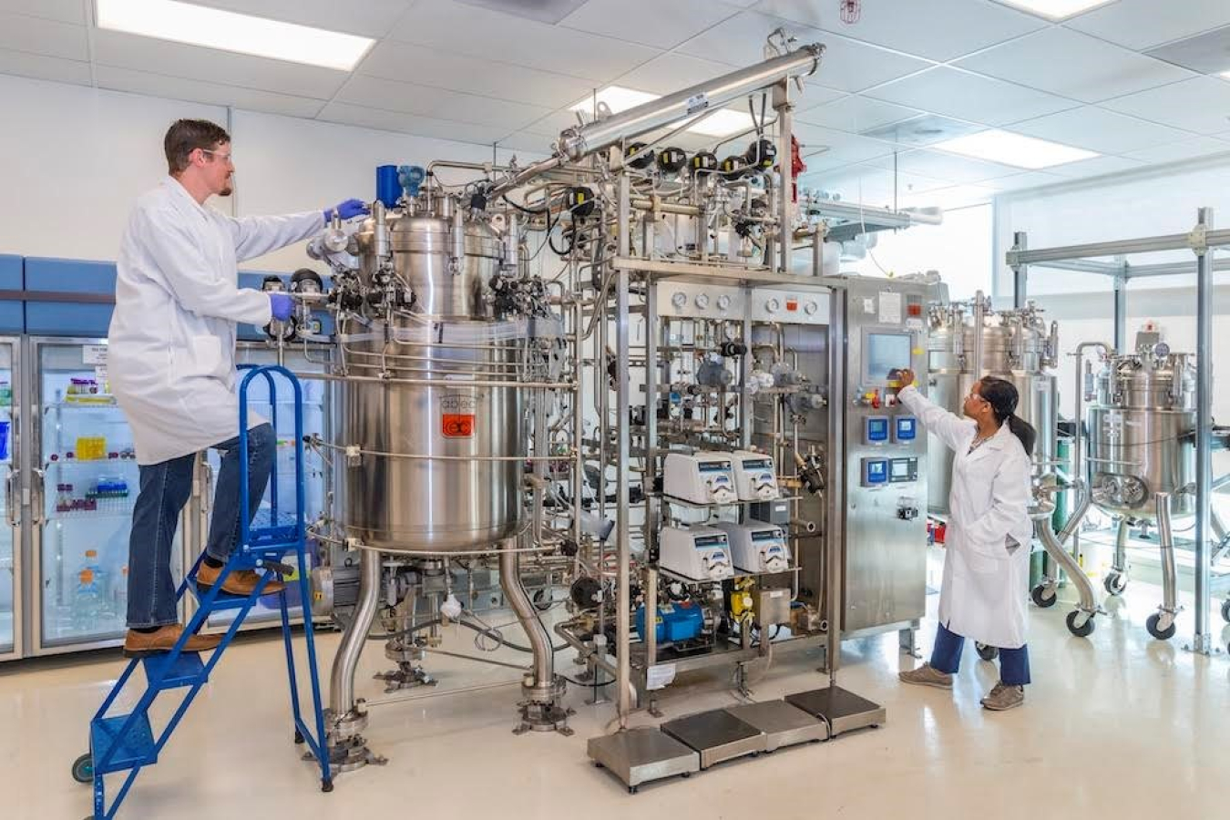 Two scientists work on lab equipment at the Advanced Biofuels Process Development Unit