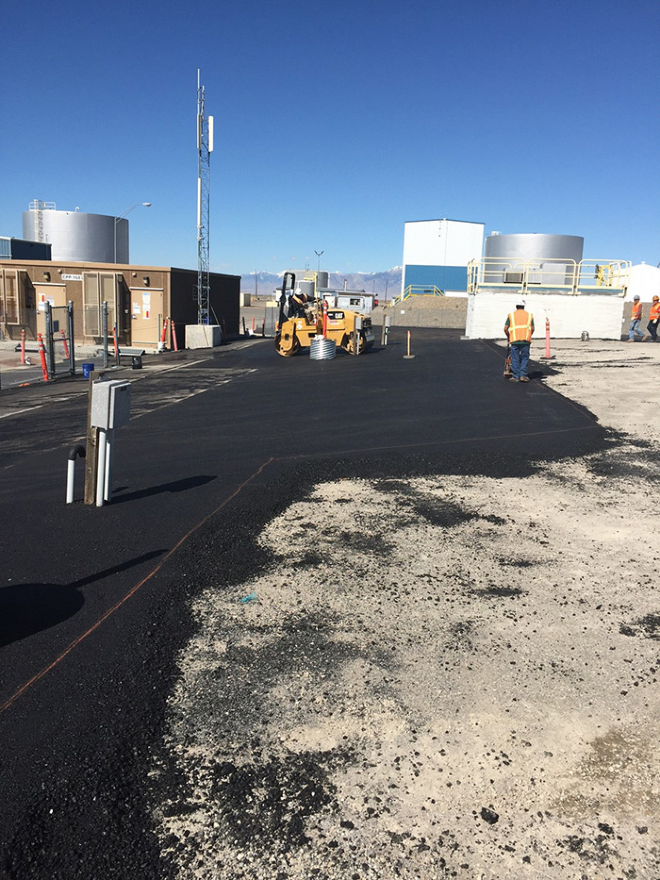 Asphalt placement and compacting on the west side of the Idaho Nuclear Technology and Engineering Center Tank Farm.