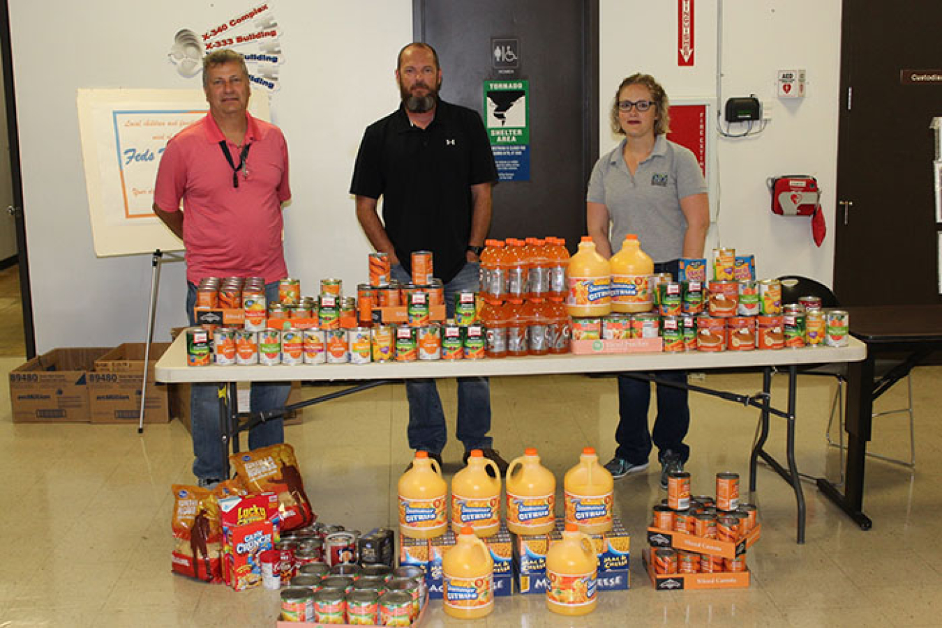 Left to right, the Portsmouth Site’s Bryan Davis and Robert Henry, and contractor Restoration Services Inc.’s Abigail Parish take part in a Portsmouth/Paducah Project Office contest for the 2017 Feds Feed Families food drive.