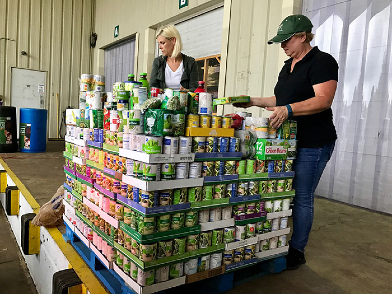 Portsmouth/Paducah Project Office’s Paula Rhea (right) and Kearney Ackermann of contractor Mid-America Conversion Services top off a load of Lexington’s donations for the 2017 Feds Feed Families food drive.