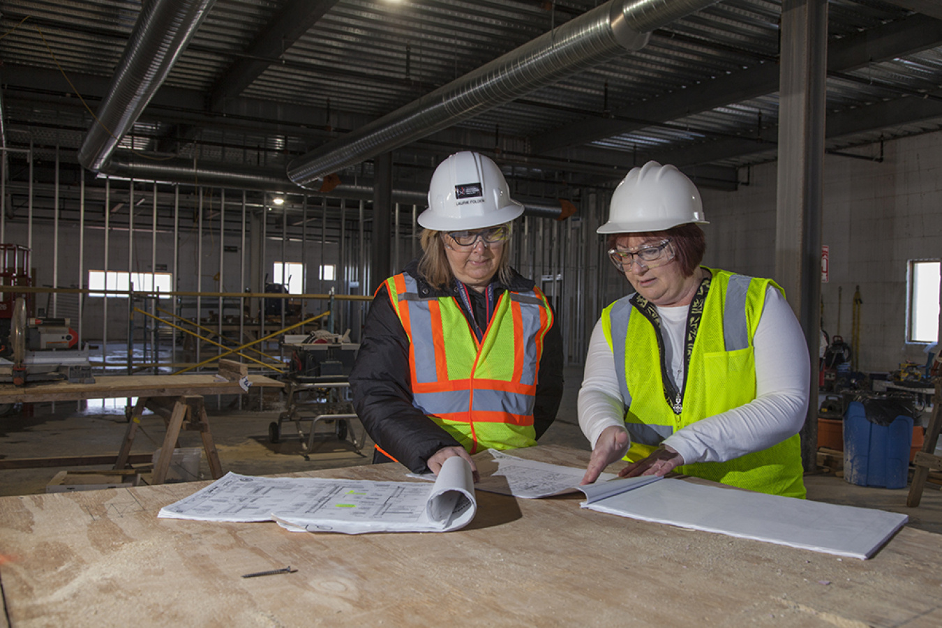 NNSA's Laurie Folden and Pam Gorman study blueprints on a job site at Y-12 National Security Complex