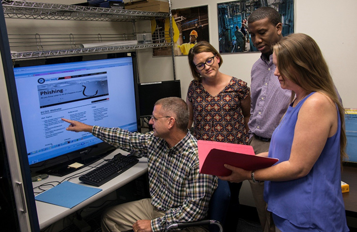 Dr. Barry McIntosh, Lizzie Tinker, Henry Bryant, and Tiffany Sprinkle of Savannah River Nuclear Solutions share cyber security training ideas.