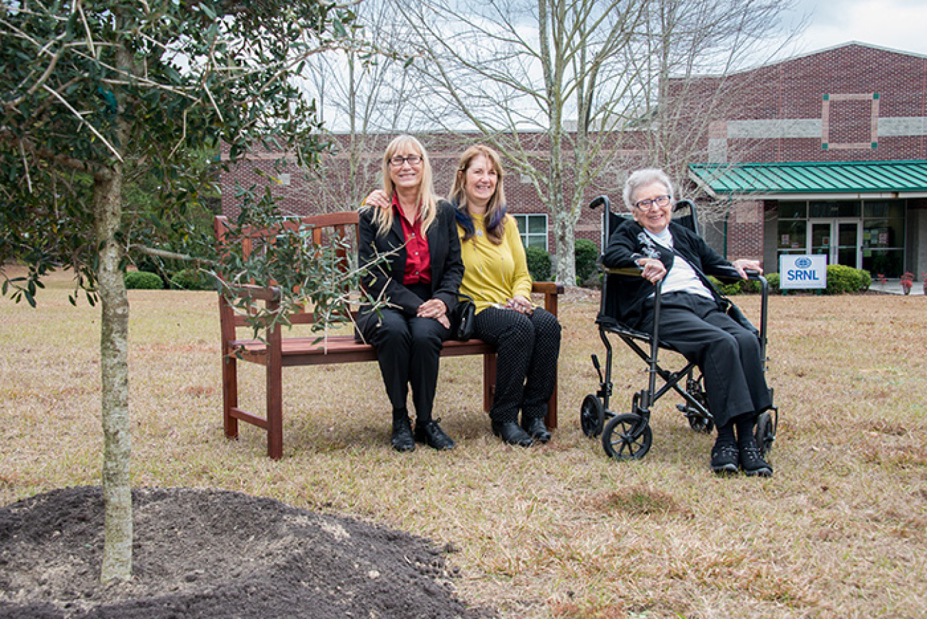To commemorate Dr. Donald Orth’s contributions to SRS, a tree and bench have been placed on the grounds of the Savannah River Research Campus, near Aiken, S.C. The memorial was given by daughters Claudia (left) and Donna (middle), and wife Jean (right).
