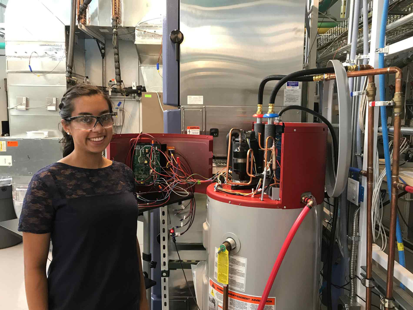 Woman next to a residential water heater