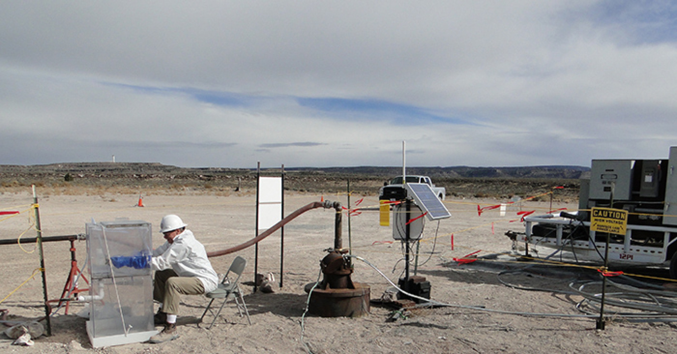 Navarro personnel collect groundwater at a groundwater monitoring well site.