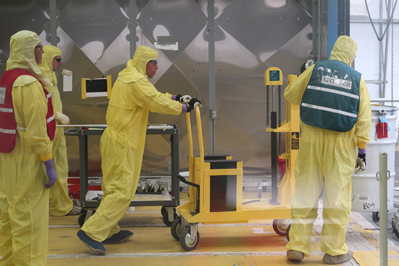 Technicians load the last remediated nitrate salt drum for transportation to the treatment facility.