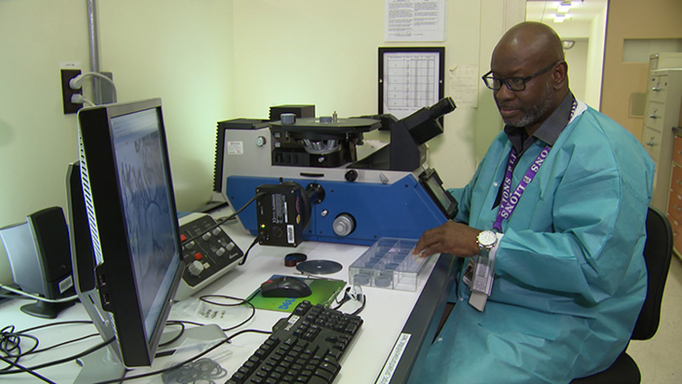 Savannah River Nuclear Solutions employee Tony Curtis uses an optical microscope, a principal tool in structural evaluation, to survey and look for defects in metal.  