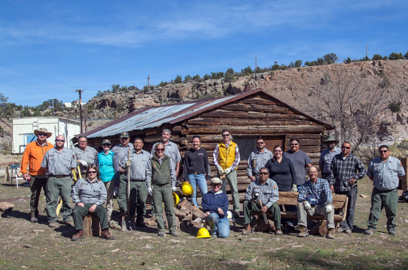 Participants at an NPS preservation workshop take a break from their work on the Pond Cabin, part of MAPR in Los Alamos, New Mexico.
