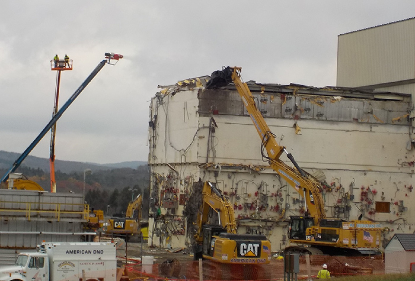 Workers tear down portions of the Vitrification Facility with the least radiological contamination in the first phase of demolition.