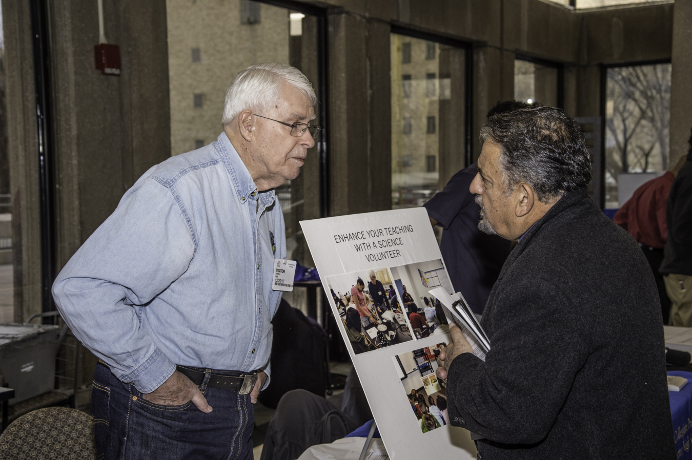 A visitor speaks with a STEM organization at the STEM Volunteer Fair.