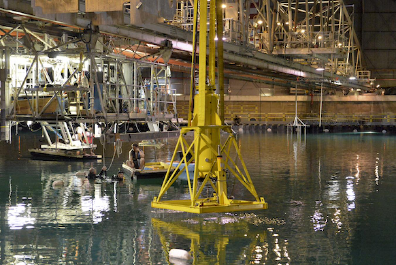 Waveswing America, one of the nine remaining Finalist Teams competing in the Wave Energy Prize, prepares to test its proposed wave-energy converter (WEC) device inside the U.S. Navy's Manuevering and Seekeaping (MASK) Basin
