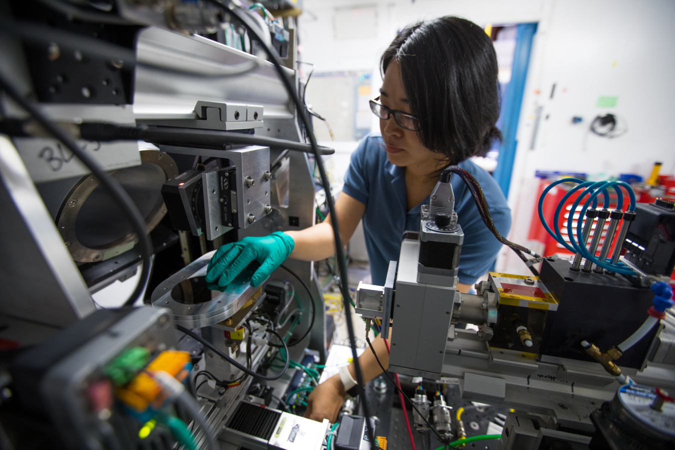 Dr. Fang Ren, a postdoctoral fellow at SLAC, loads a combinatorial library on the high throughput data collector at the Stanford Synchrotron Radiation Lightsource at SLAC. 