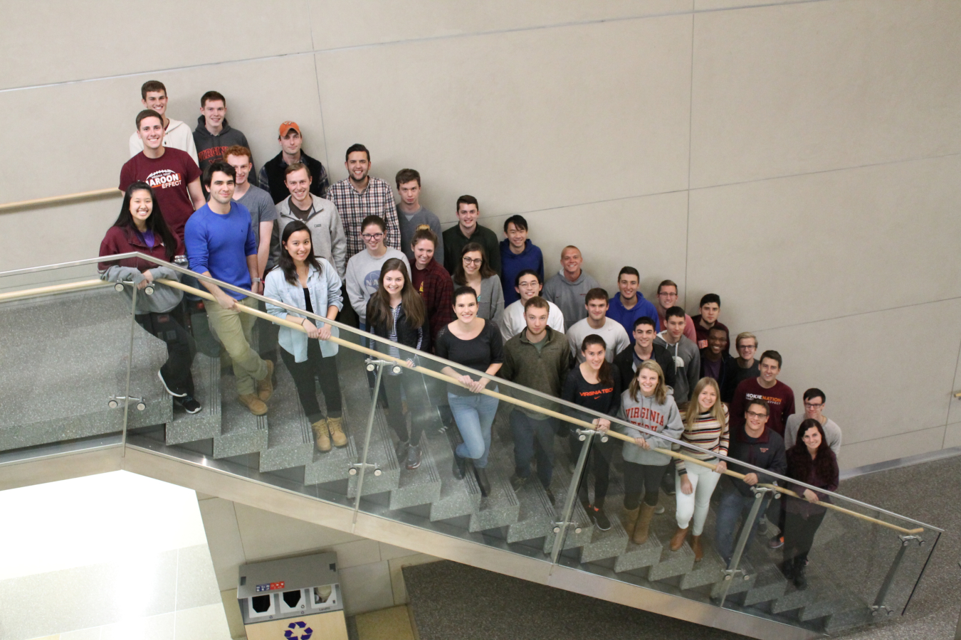 Virginia Tech students stand on a staircase