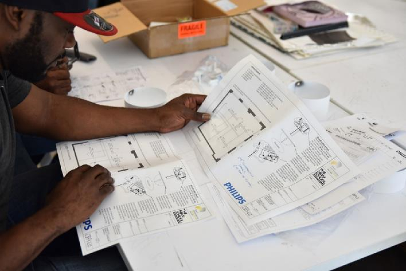 Photo of a man reading a specification sheet.