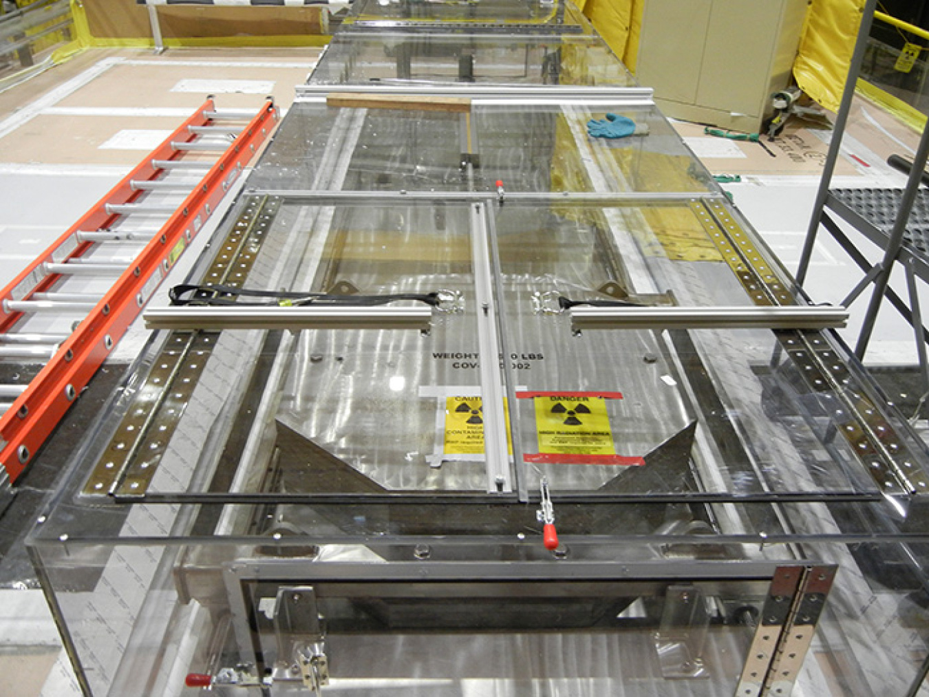 Workers fabricated a port cover actuator mechanism to allow operators to open and close the hot cell’s hatch cover with a cordless drill.