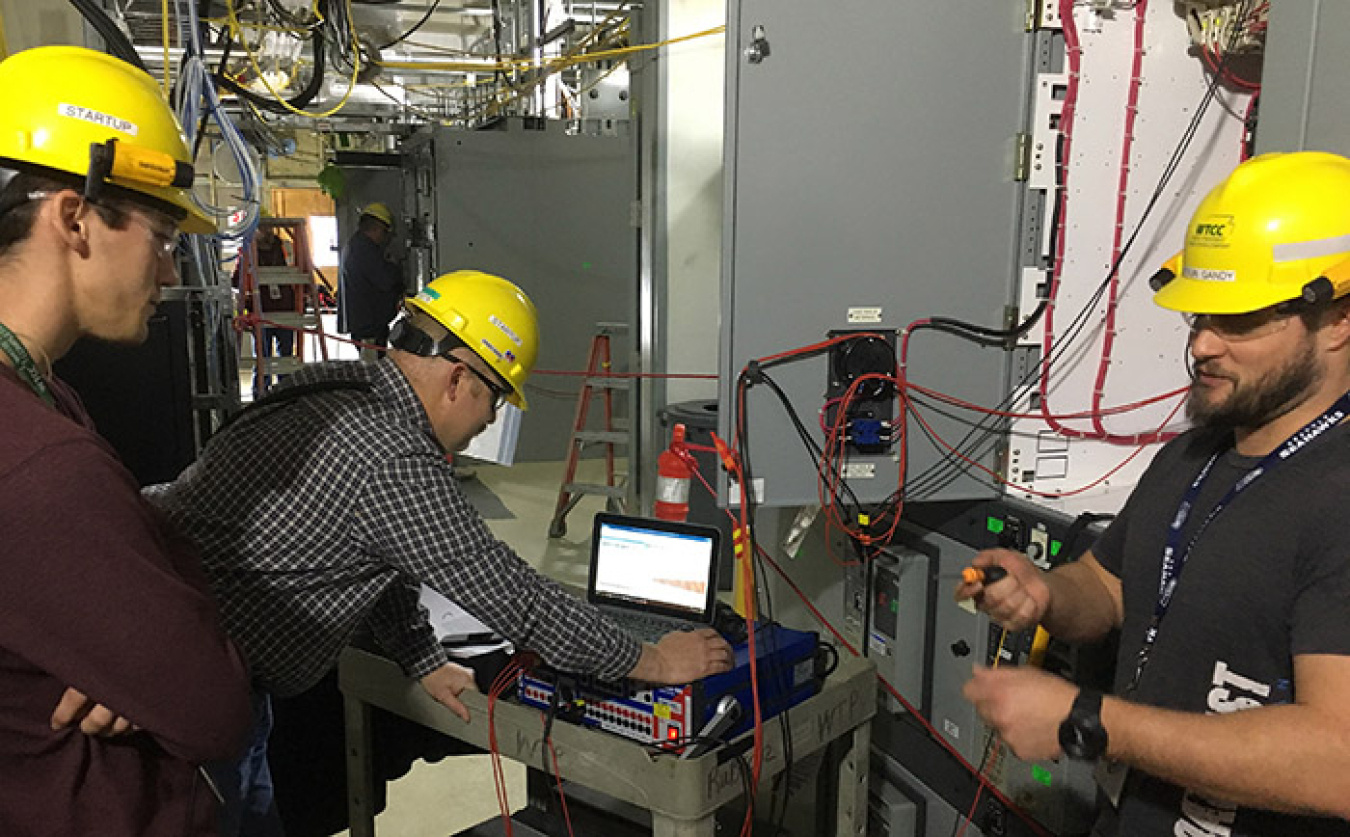 Startup team members (from left) Chad Schrumpf, T.C. Bonham, and Tyson Gandy test the control system in the Analytical Laboratory at the Waste Treatment and Immobilization Plant.