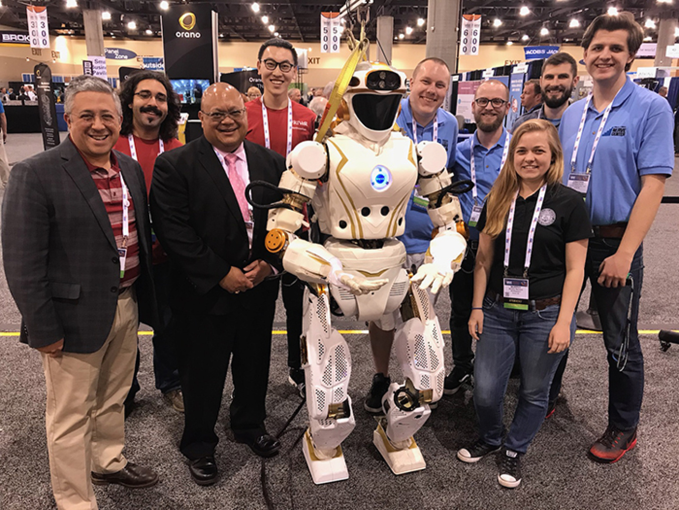 NASA's humanoid robot, Valkyrie, gathers with participants in this year's Waste Management Symposia, including Rod Rimando, director of EM’s Office of Technology Development, at left of Valkyrie.