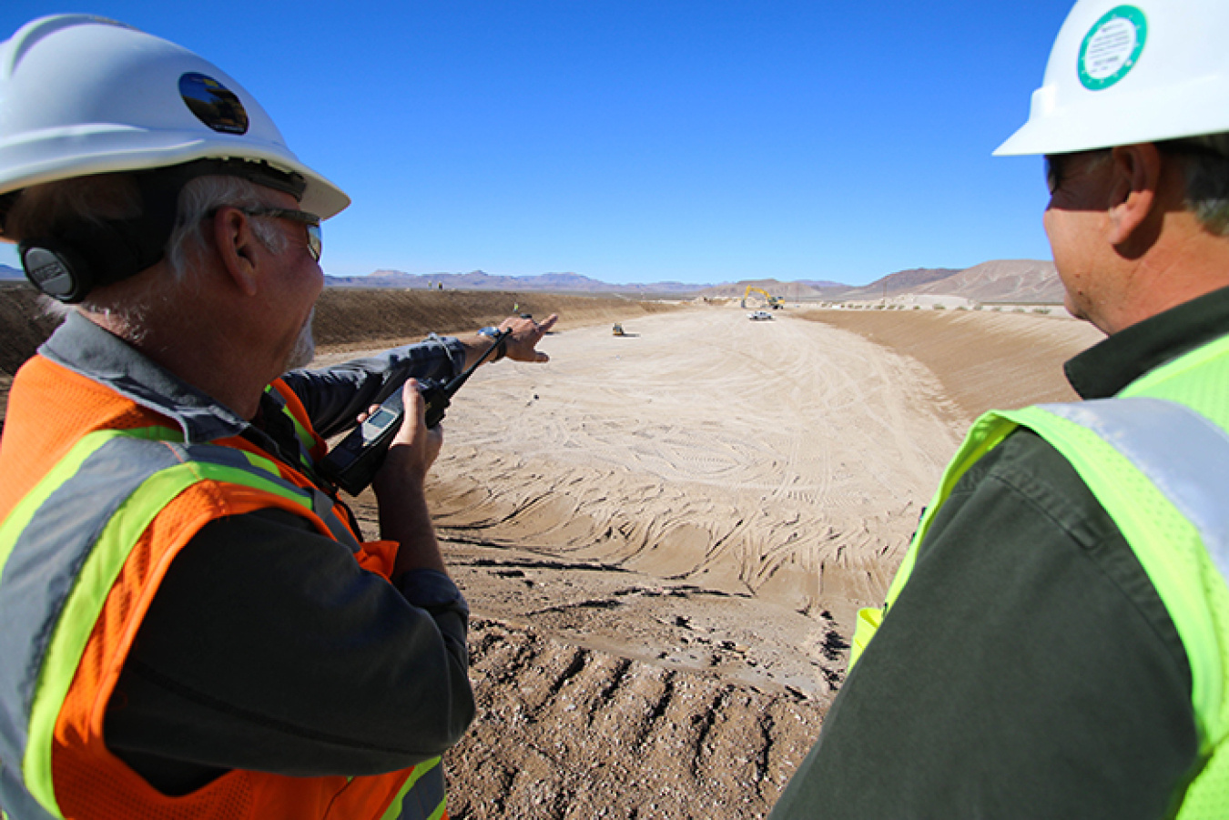 Supervisors oversee excavation and grading of the disposal cell.