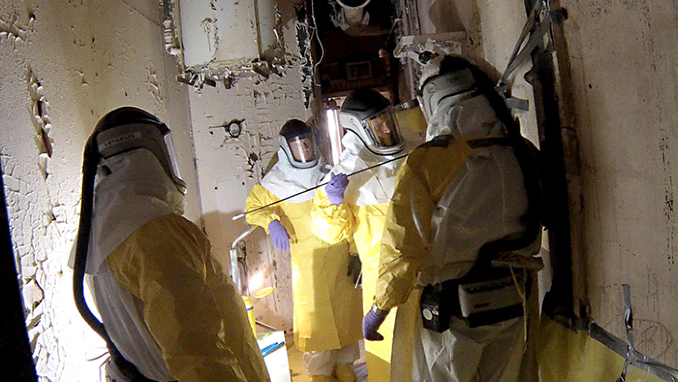 Workers conduct "fogging" to plate interior surfaces.
