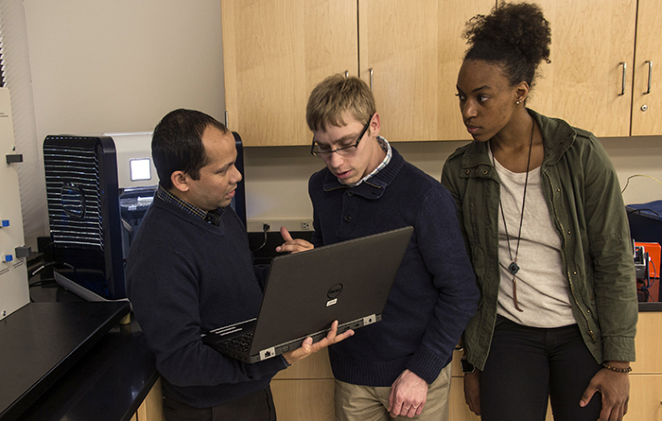 University of South Carolina Aiken (USCA) students Brandon Eberl (center) and Shayla Baldwin (right) receive instruction from USCA Engineering Professor Titan Paul on using 3-D printers to create unique objects to solve difficult engineering applications.