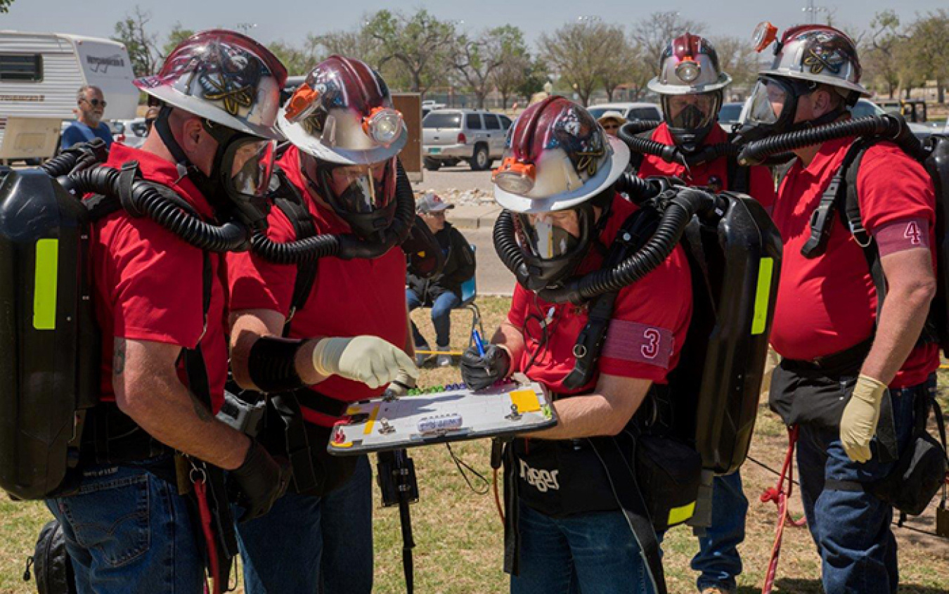 Waste Isolation Pilot Plant Red Team members study the mine map during the mine rescue team competition.