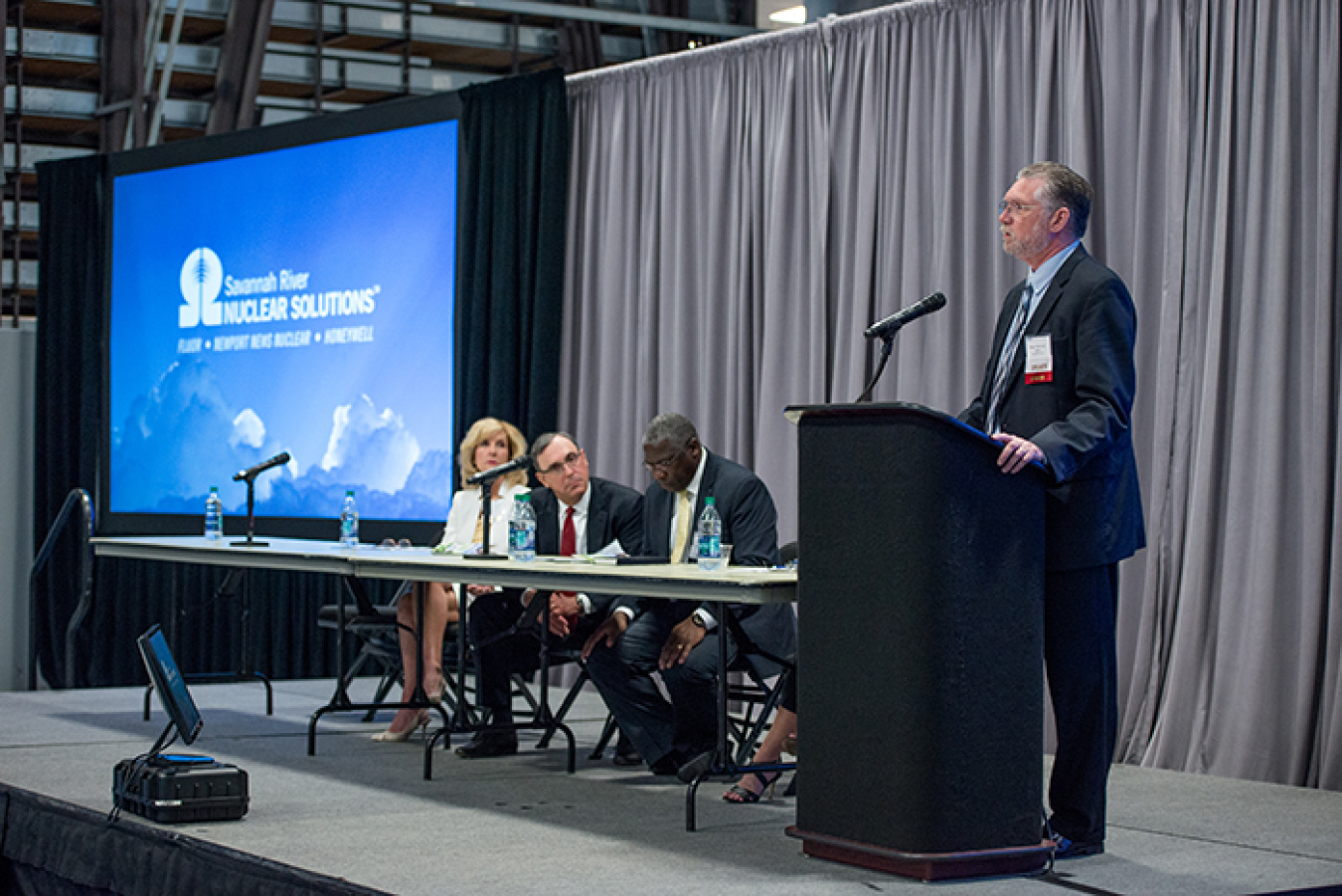 Savannah River Nuclear Solutions President and CEO Stuart MacVean (right) addresses the Federal Business Opportunities Forum audience as part of a panel session.