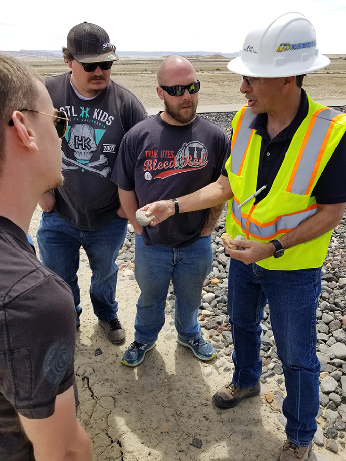 Students from the University of Utah gather around Senior Program Manager Joe Ritchey while he explains the soil and rock used in the disposal cell cover at the Crescent Junction Site.