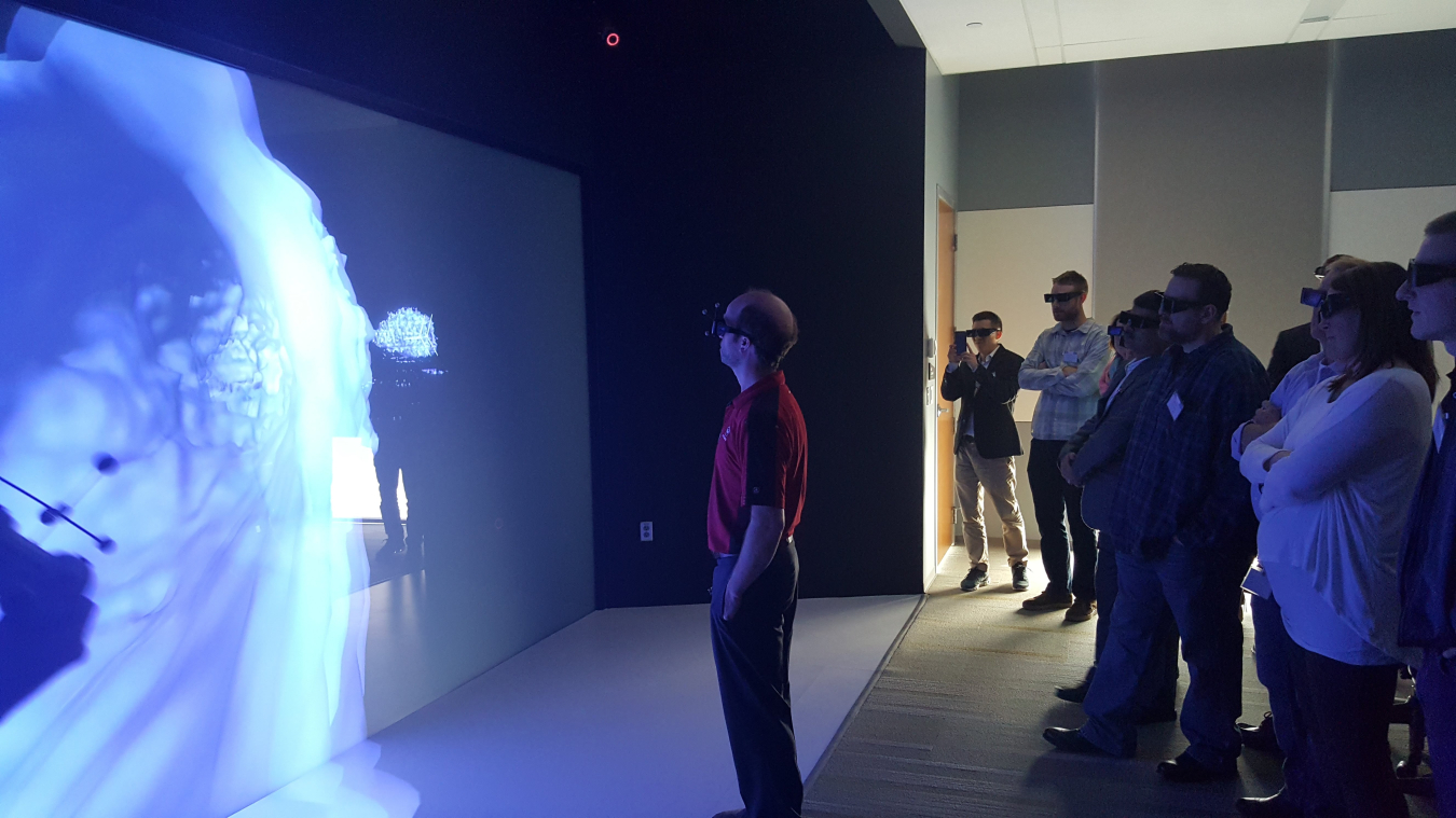 Technology Days participants explore an interactive, 3D visualization of wind patterns in NREL’s Energy System Integration Facility Insight Center.