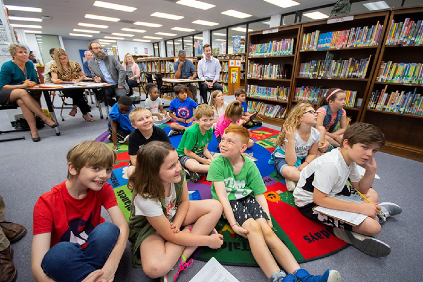 Students eagerly wait their turn to share what they’ve learned.