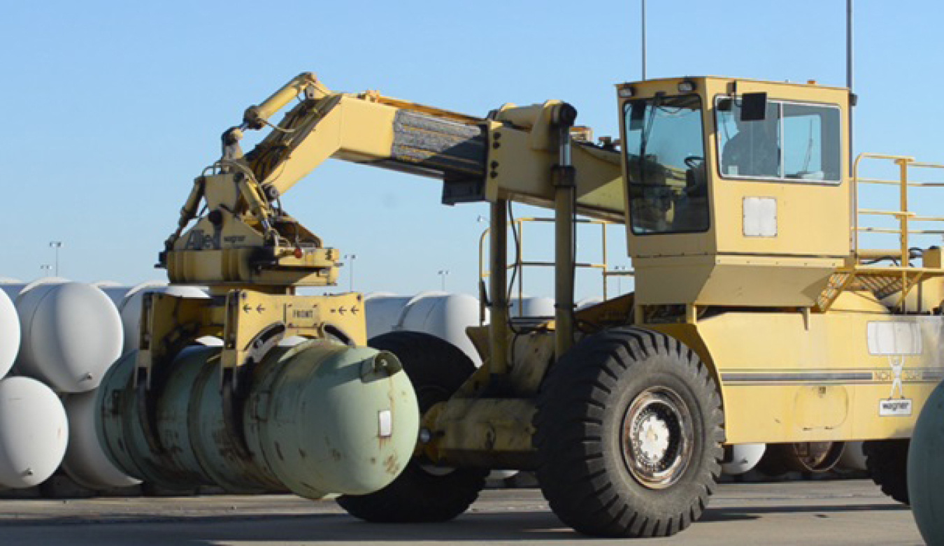 A Mid-America Conversion Services employee moves a Depleted Uranium Hexafluoride cylinder within a Paducah Site storage yard.