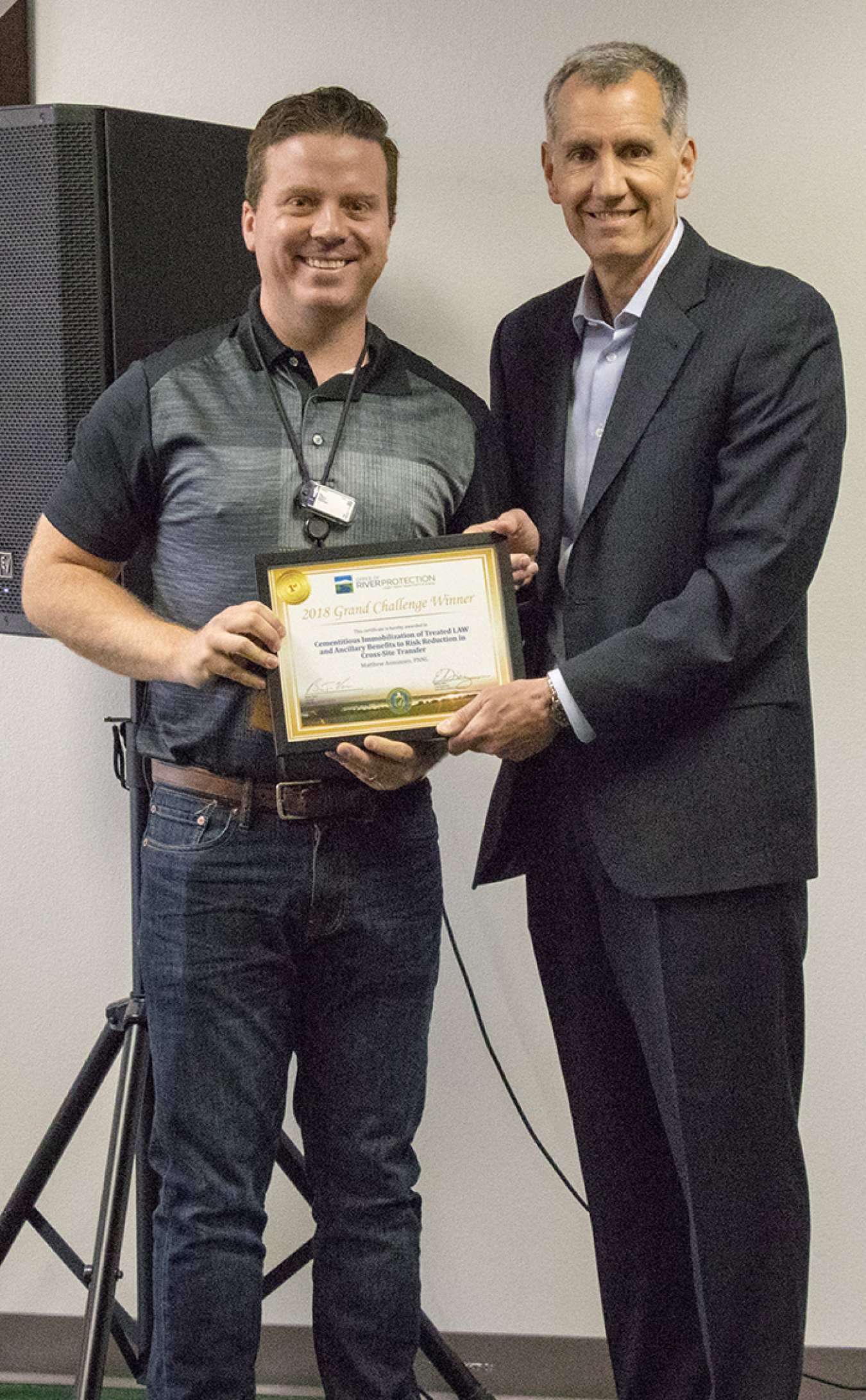 EM Office of River Protection Manager Brian Vance, right, presents a certificate to Matthew Asmussen of Pacific Northwest National Laboratory, whose team won this year’s Grand Challenge competition.