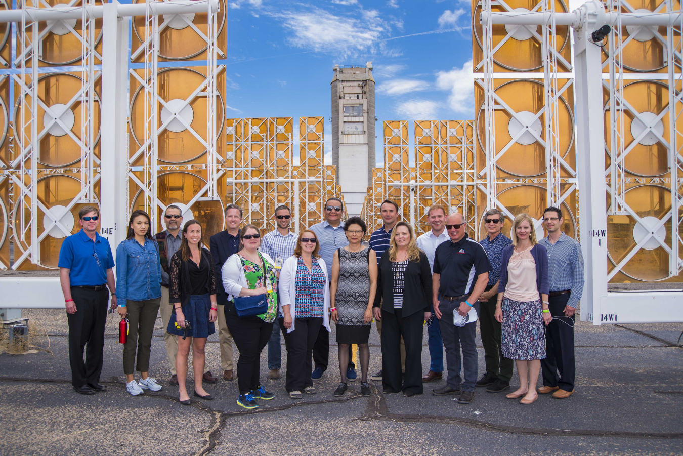 Members of ICEIWG standing in front of solar panels.