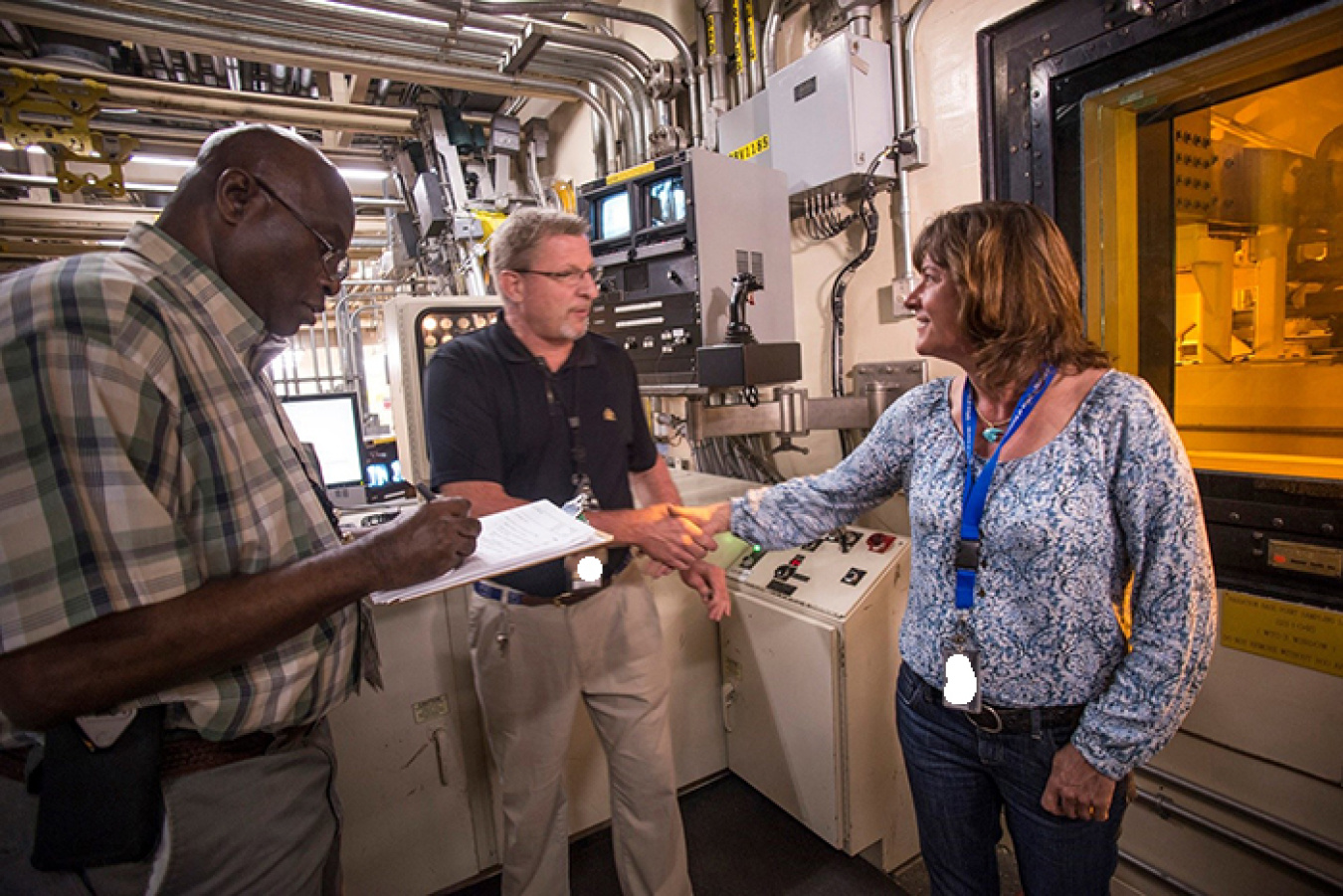 EM Assistant Secretary Anne White meets Defense Waste Processing Facility operators Ben Anderson and Robert Wallace.