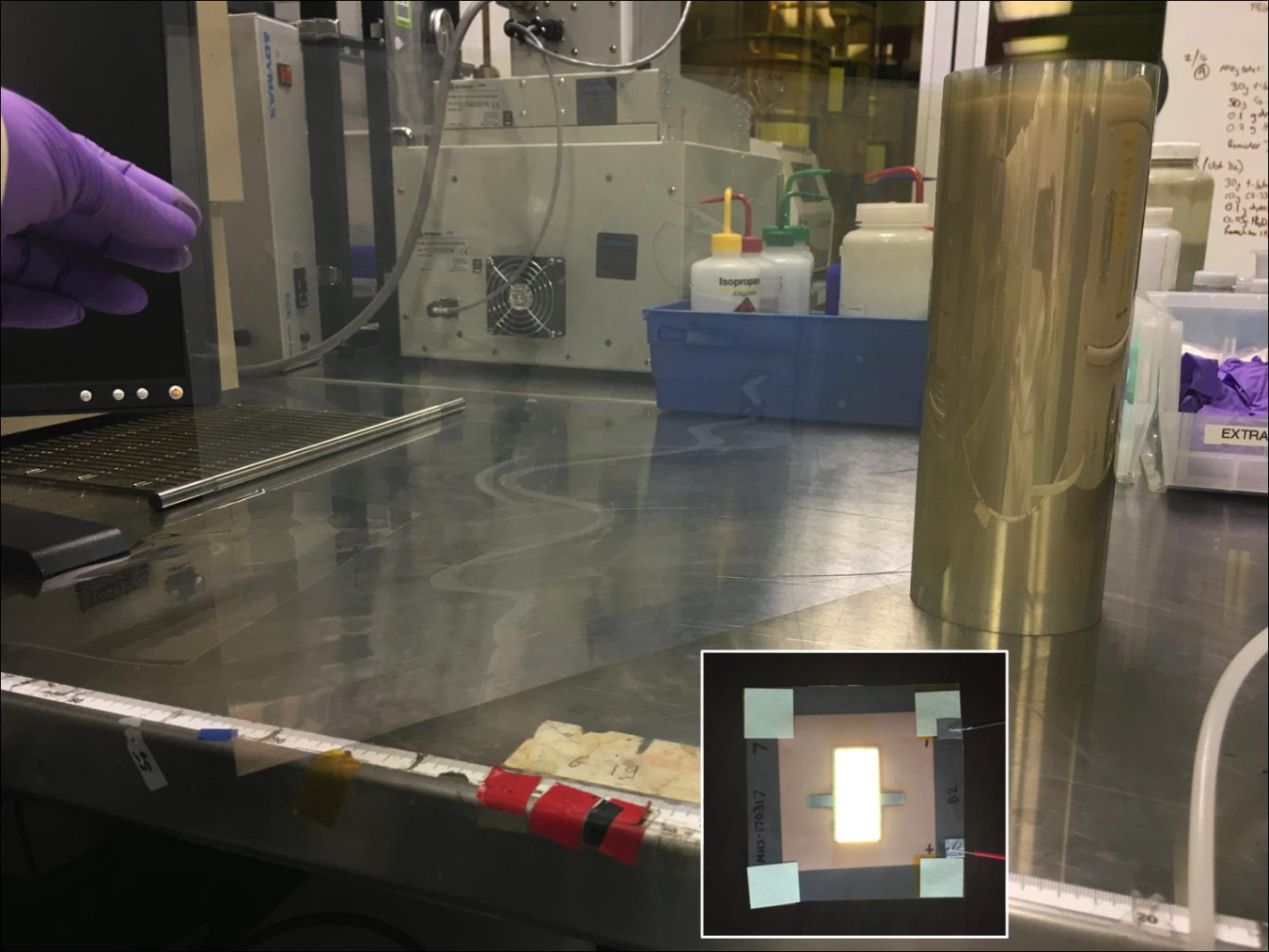 Photo showing manufacturing of OLED substrates, with an inset showing an OLED fabricated with the substrate.