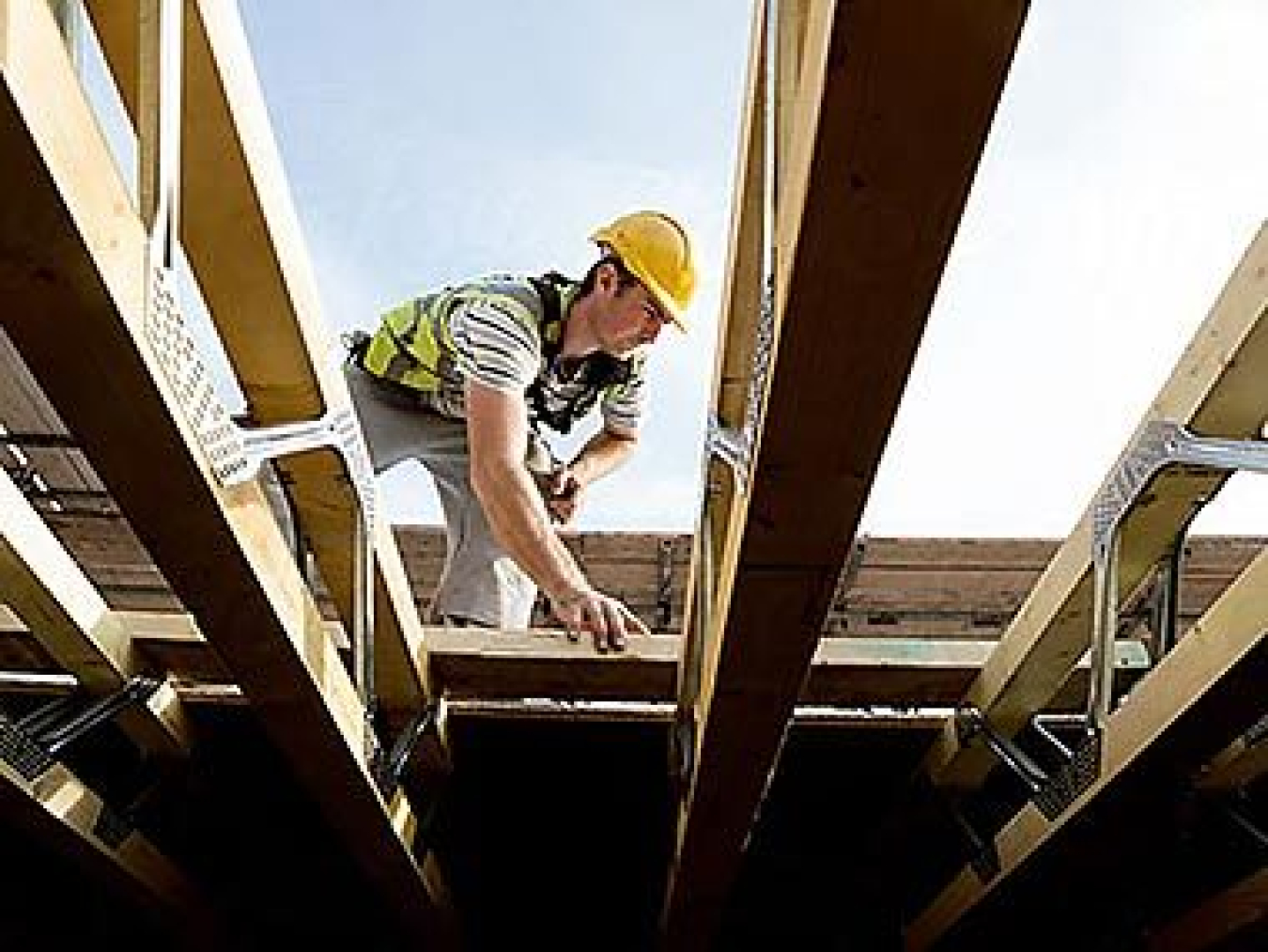 A construction worker framing a house.