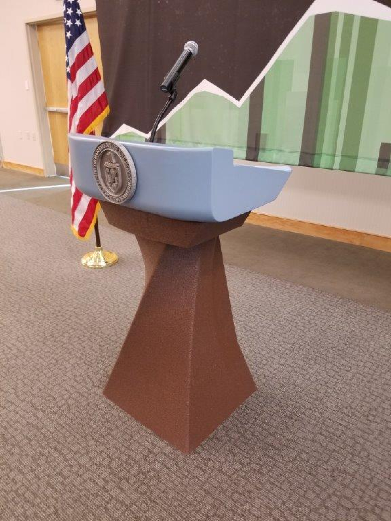 a 3D printed podium, and an american flag in the background.