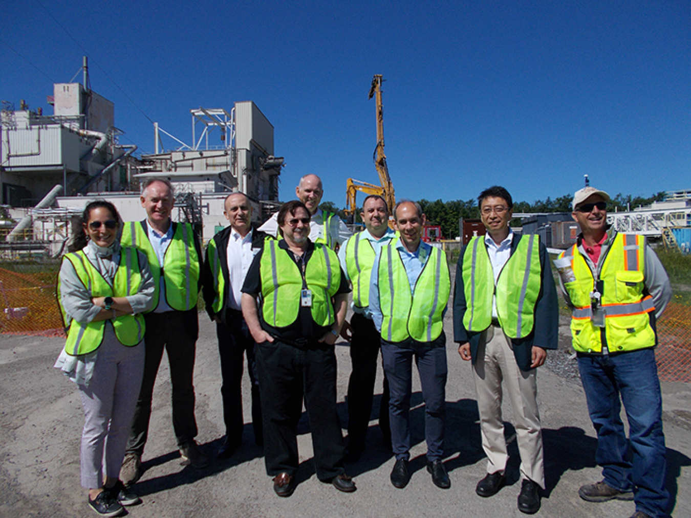 Members of the International Decommissioning Network Steering Committee stand with Tom Dogal of EM’s West Valley Demonstration Project, far right, near the Vitrification Facility demolition site during their recent tour.