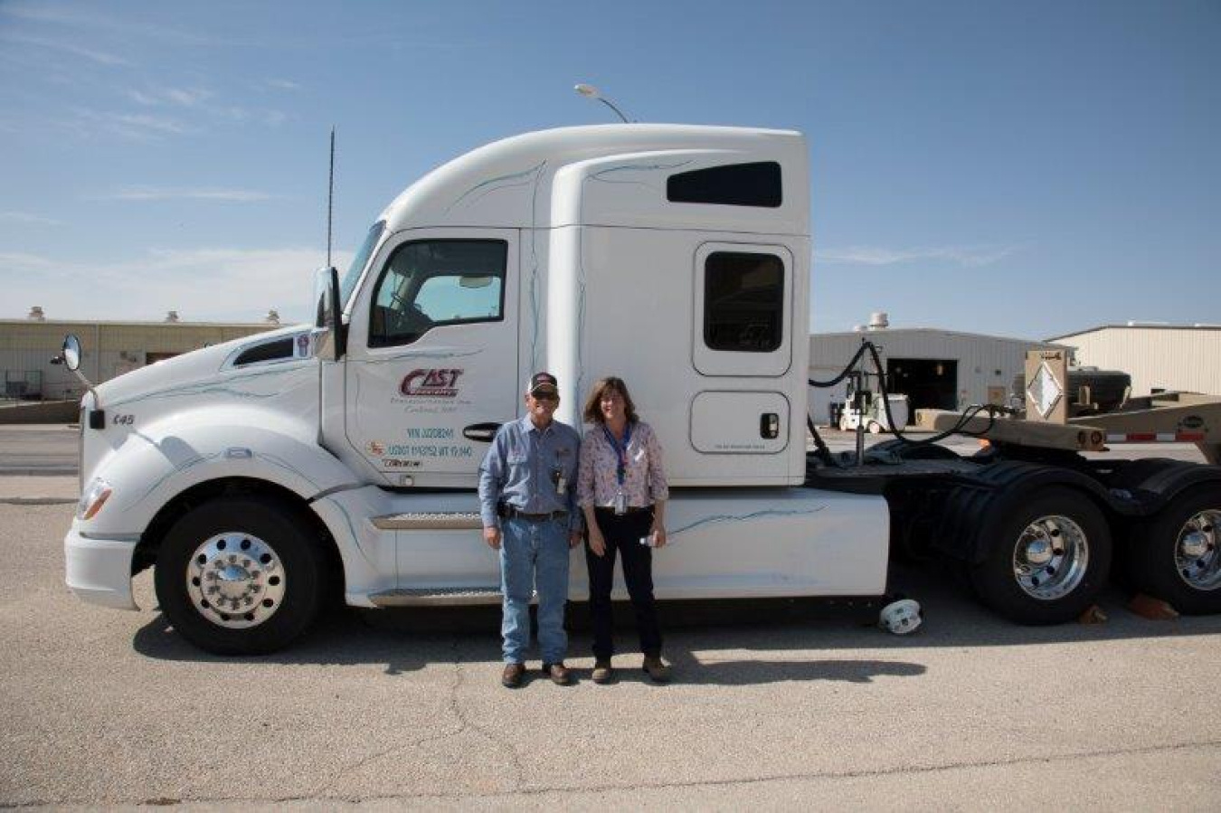EM Assistant Secretary Anne White stands with CAST Transportation driver Greg Grimm.