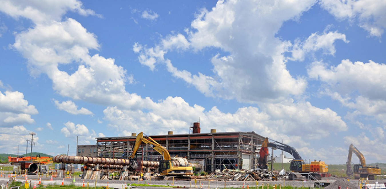 Equipment operators tear down the 18,100-square-foot contaminated facility located in the Poplar Creek area of the East Tennessee Technology Park.