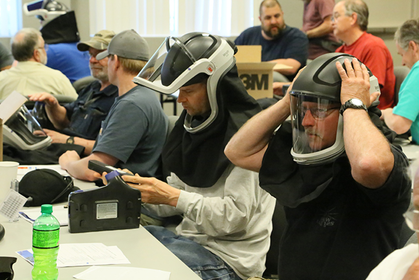 Bonneville Power Administration employees participate in hands-on training with helmets that contain powered air-purifying respirators in a course led by worker-trainers at the HAMMER Federal Training Center.