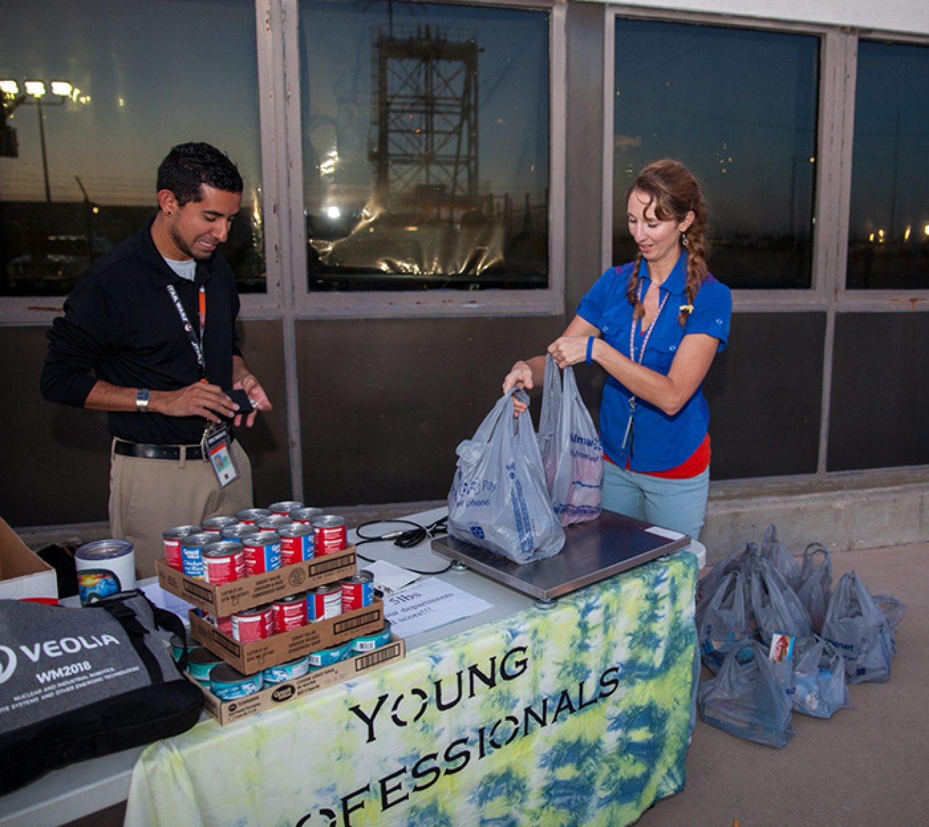 Chris Dominguez and Sheree Turner of the Waste Isolation Pilot Plant Young Professionals group volunteer at a food drive.
