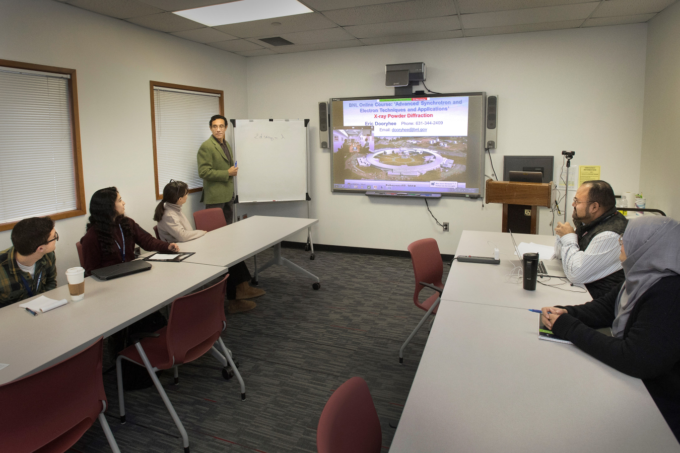 Brookhaven Lab physicist Eric Dooryhee explains how he uses x-ray powder diffraction at the National Synchrotron Light Source II to determine the structure of materials. Five other Universities participated via videoteleconference. 