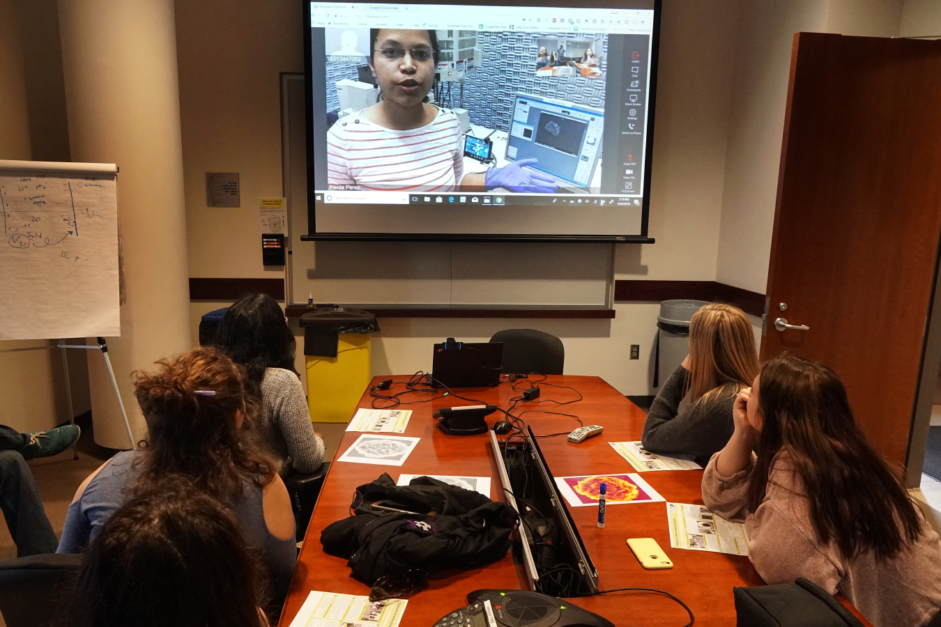 Stony Brook University graduate student Shruti Sharma uses a scanning electron microscope at Brookhaven Lab's Center for Functional Nanomaterials to image samples of graphene oxide microspheres synthesized by 11th-grade female students.