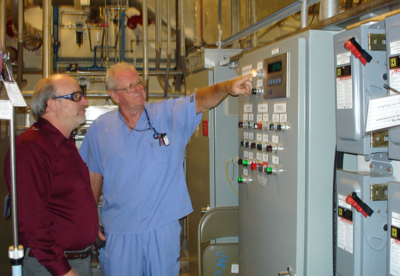 Mid-America Conversion Services Operator Bobby Ferren, right, is pictured with EM Depleted Uranium Hexafluoride Deputy Federal Project Director James Johnson at the Paducah cylinder transfer system startup.