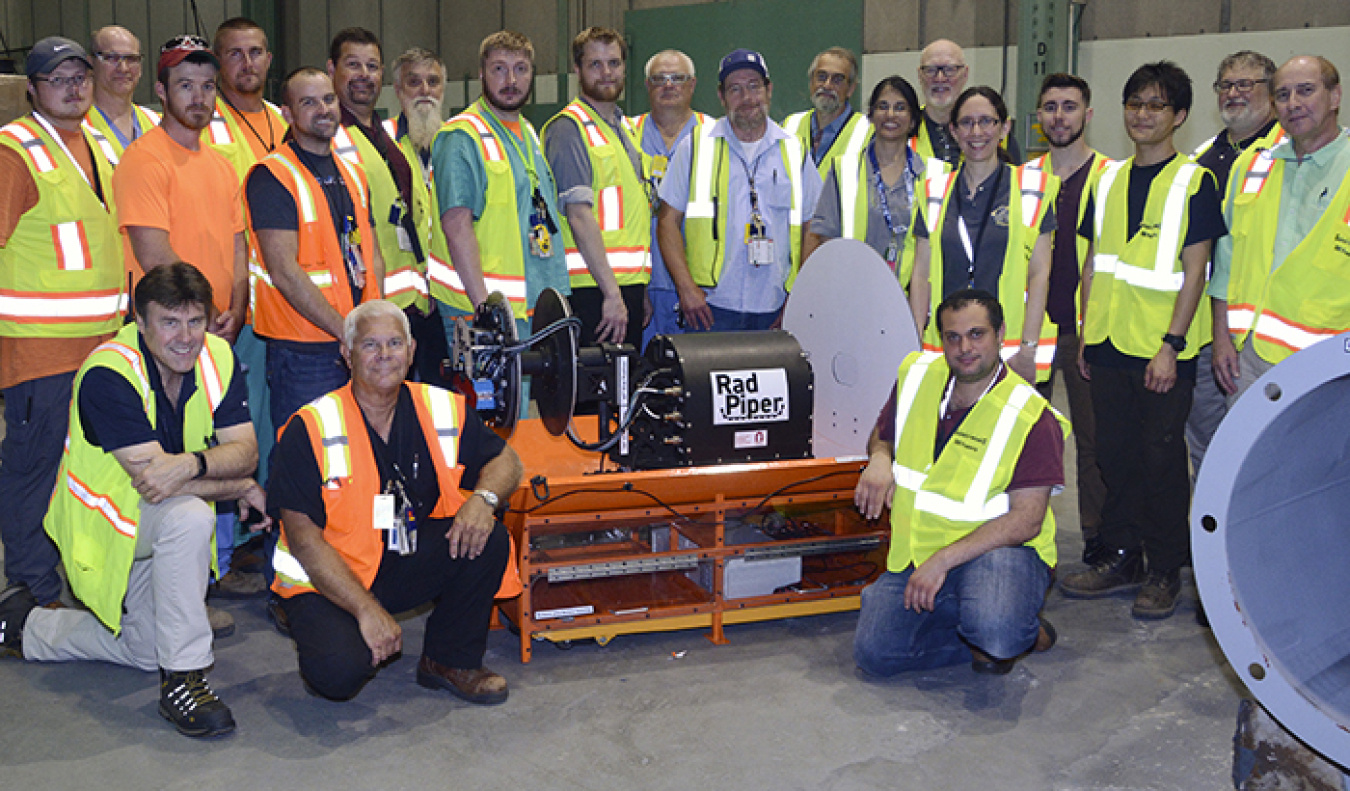 A Radpiper takes a break between test runs in the Portsmouth X-333 Process Building’s enrichment cascade with CMU and FBP team members.